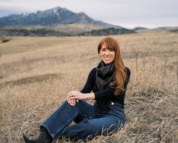 Sarah sitting with the Bridgers in the background